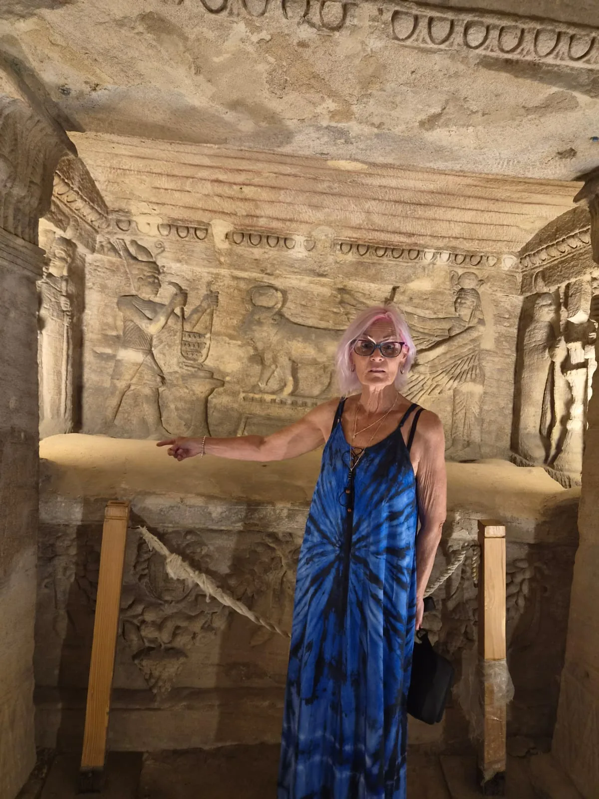 Visitor in a carved chamber of the Catacombs of Kom el Shoqafa in Alexandria