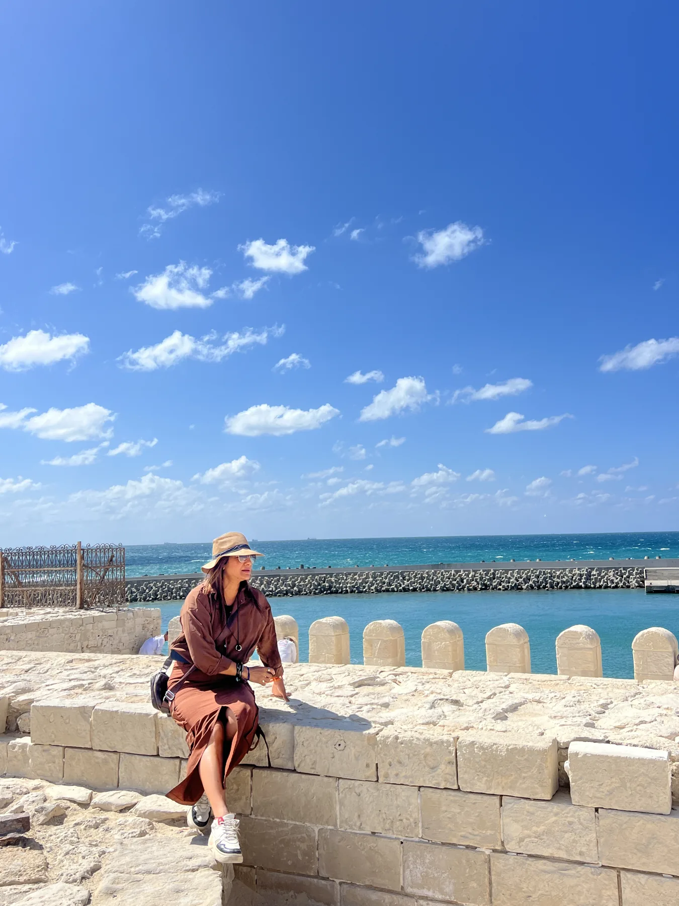 Visitor sitting by the Mediterranean waterfront in Alexandria
