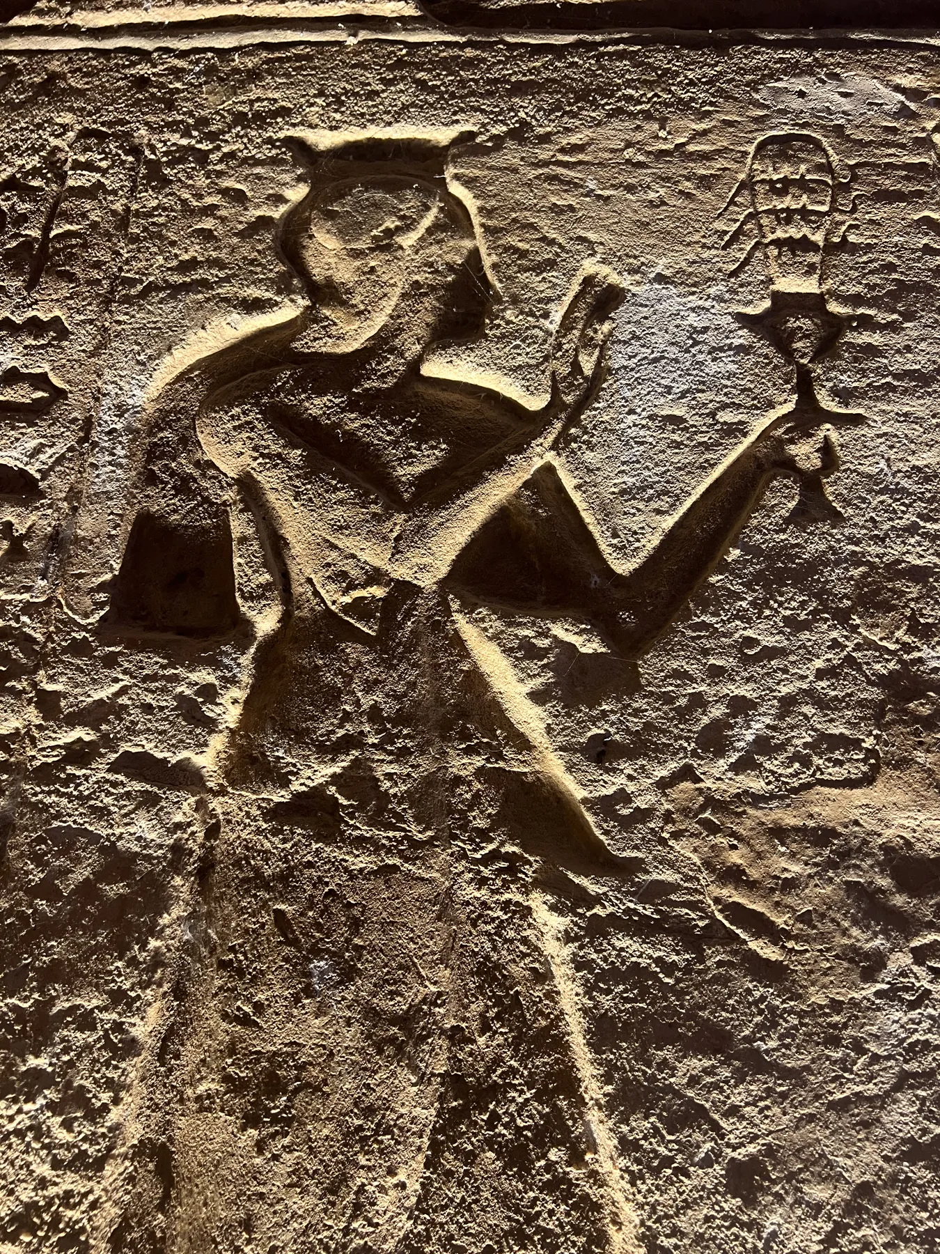 Ancient Egyptian relief carving during temple sightseeing in Aswan