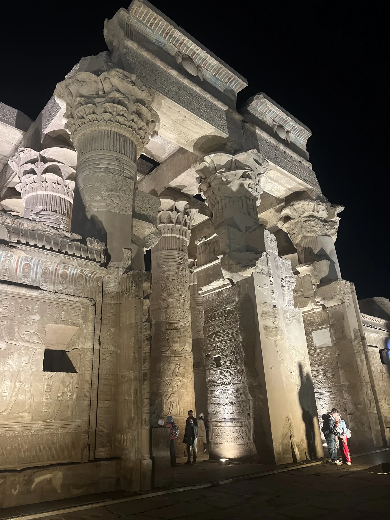Illuminated temple columns at Kom Ombo beside the Nile