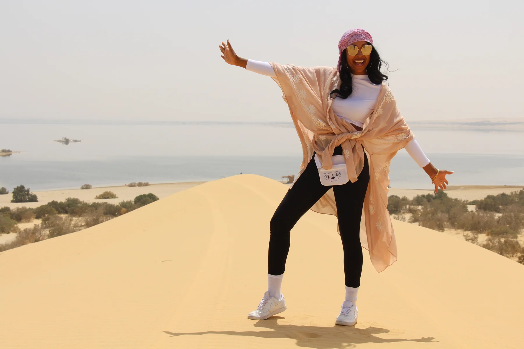 Traveler overlooking the desert lake from the Fayoum sand dunes